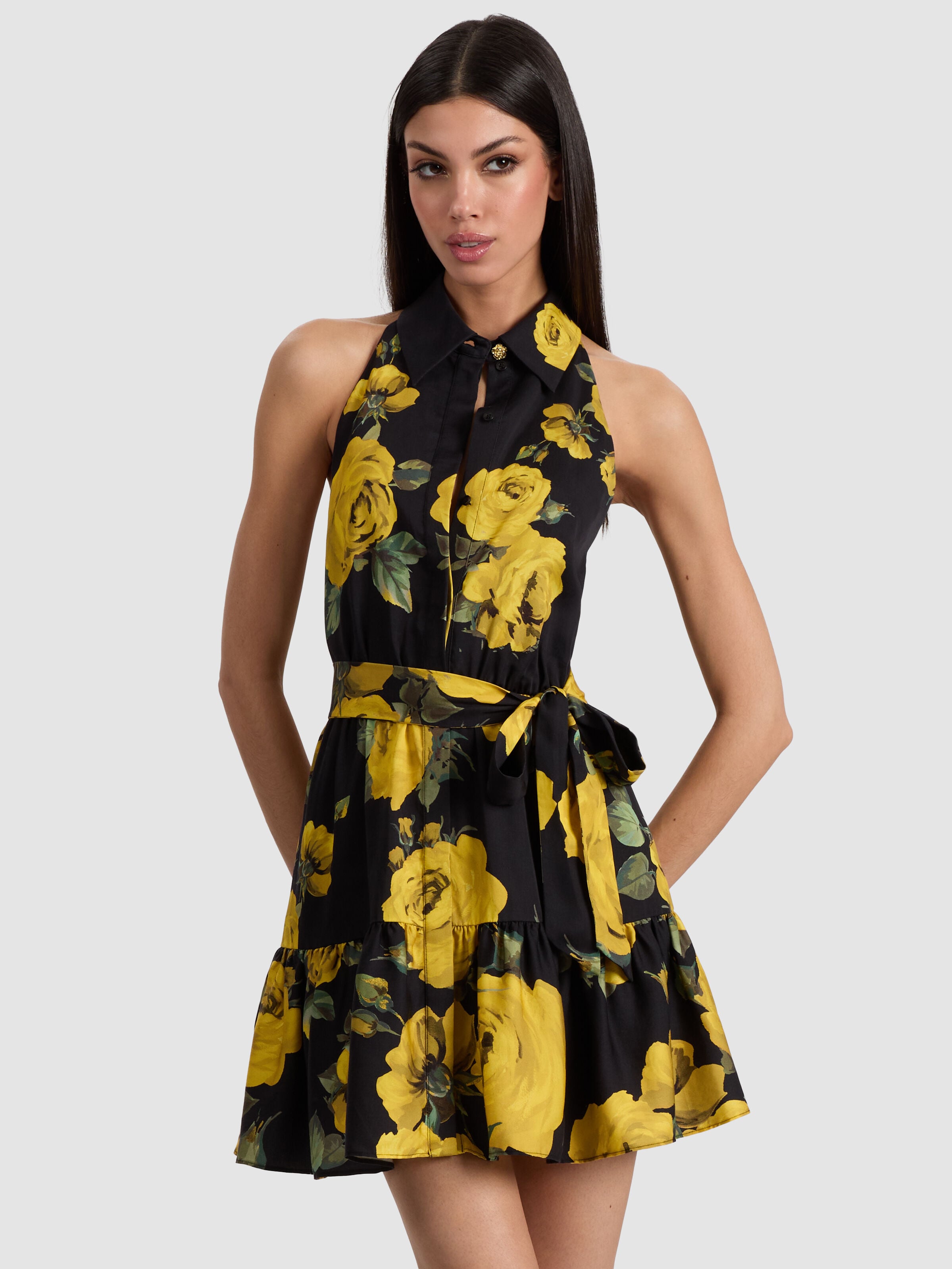 A model wearing a lightweight floral sundress with spaghetti straps and a flared skirt, styled for a casual outdoor brunch or beach vacation